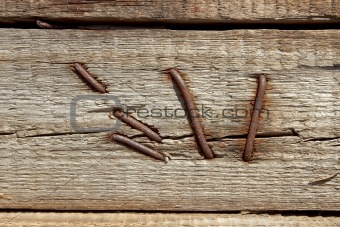 Rusty nails in wooden shield