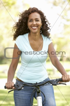Woman Riding Bike In Park