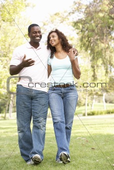 Portrait Of Young Couple Walking In Park