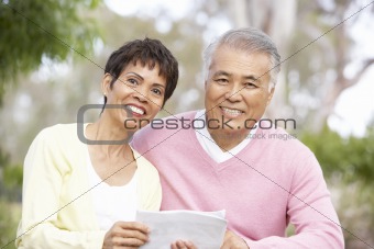 Portrait Of Senior Couple Looking At Map