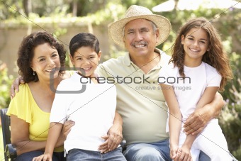 Portrait Of Grandparents With Grandchildren In Park