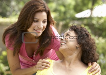 Senior Woman With Adult Daughter In Garden