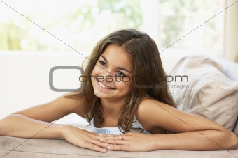 Young Girl Relaxing On Sofa At Home