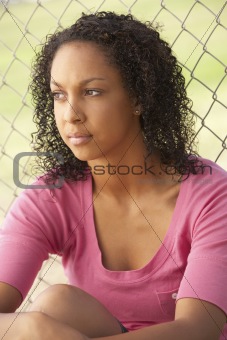 Teenage Girl Sitting In Playground