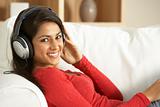 Young Woman Listening To Music At Home
