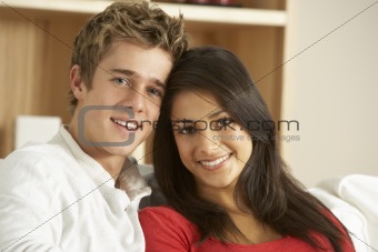 Young Couple Sitting On Sofa