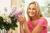 Woman At Home Arranging Flowers