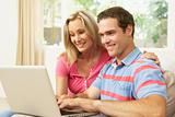 Young Couple Using Laptop At Home