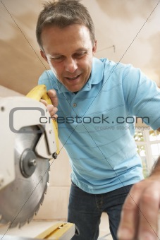 Builder Using Electric Saw