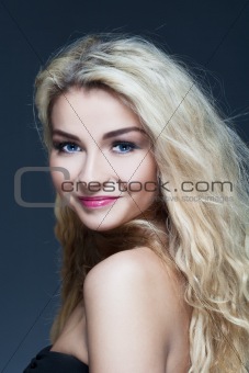 portrait of a young beautiful woman with long blond hair smiling