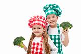 Happy chefs holding broccoli