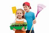 Kids with spring seedlings and gardening tools