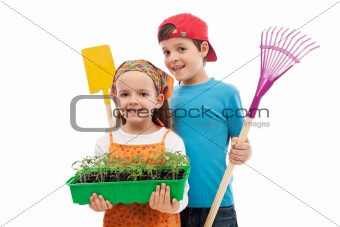 Kids with spring seedlings and gardening tools