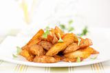 fried potato slices on a white plate