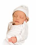 New born baby sleeping peacefully - dressed in white