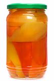 Glass jar of preserved peppers over white background
