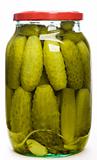 Clear glass jar of green pickled cucumbers
