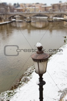 Snowy shore of the Tiber river, Rome (Italy).