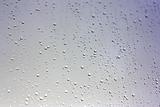 Drops of rain on the inclined window (glass)