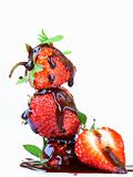 ripe and fresh strawberries with chocolate sauce on a white background