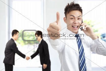 successful businessman on the phone with thumbs up