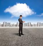 businessman holding smart phone with cloud computing background