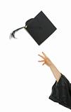 Female hand throwing up graduation cap