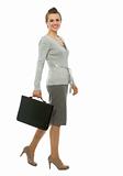 Modern business woman with briefcase walking