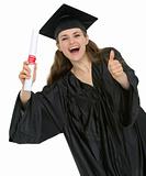 Happy graduation student girl with diploma showing thumbs up