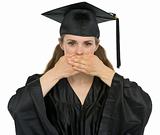 Graduation student girl making speak no evil gesture
