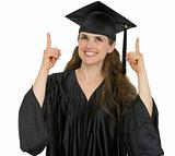 Happy graduation student girl pointing up