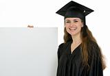 Happy graduation female student holding blank billboard