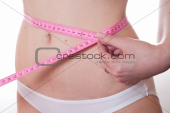 The girl measures waist volume