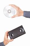Videotape and cd drive in your hand. On a white background.