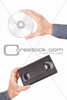 Videotape and cd drive in your hand. On a white background.