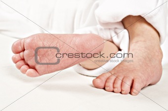 Little feet of a new born baby on white