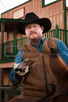 Armed Cowboy on Horseback