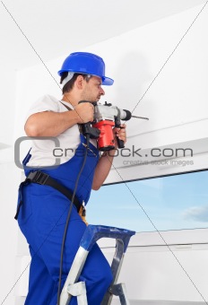 Worker drilling hole