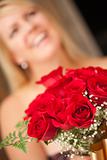 Surprised Attractive Blonde Woman Accepts Gift of Red Roses.