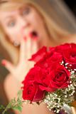 Surprised Attractive Blonde Woman Accepts Gift of Red Roses.
