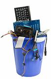 electronic scrap in blue trash can