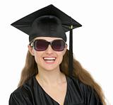 Portrait of happy graduation student girl with sunglasses