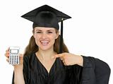 Happy graduation student woman pointing on calculator