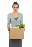 Woman employee holding box with personal items