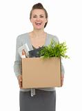 Happy woman employee holding box with personal items