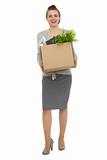 Full length portrait of happy woman employee with box with personal items