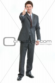 Full length portrait of businessman showing thumbs up