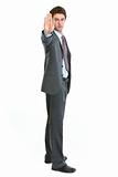 Full length portrait of businessman showing stop gesture