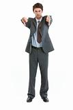 Full length portrait of businessman showing thumbs down