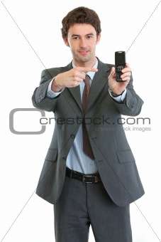Modern businessman pointing on cell phone